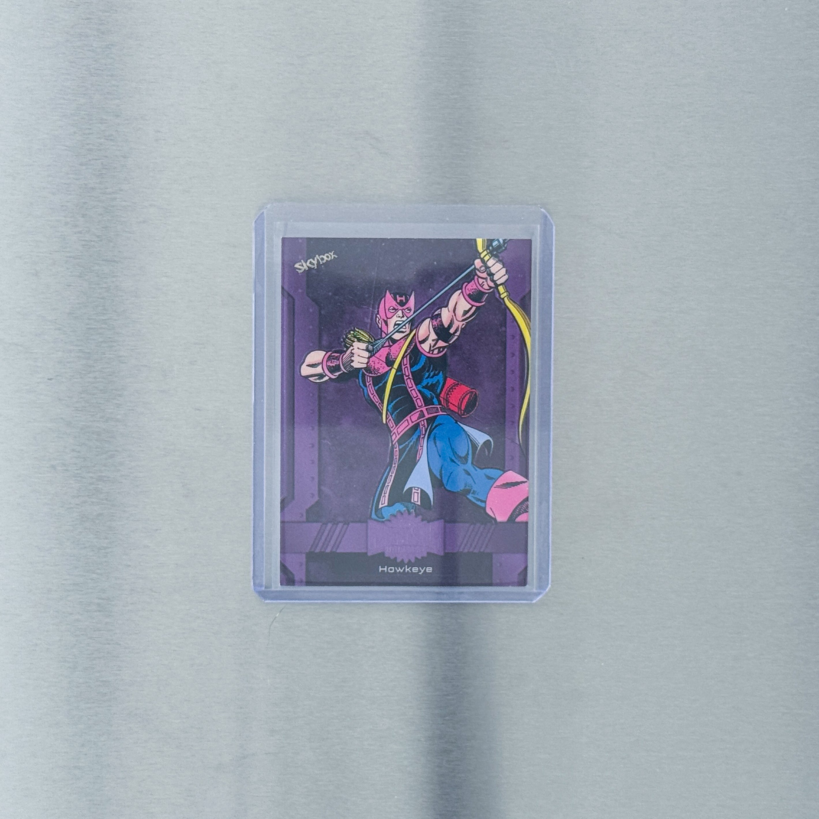 2024 SkyBox Metal Universe Avengers - Comic - Hawkeye purple 1/199